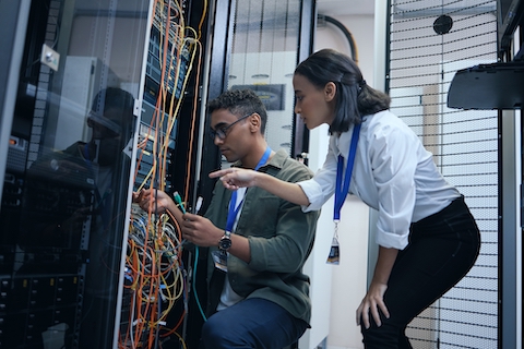 IT techs working together on a business server