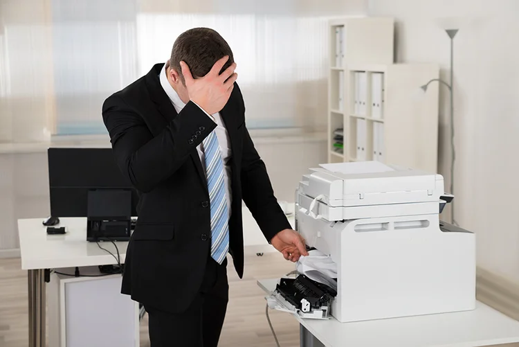 a frustrated business employee struggling with the copy machine