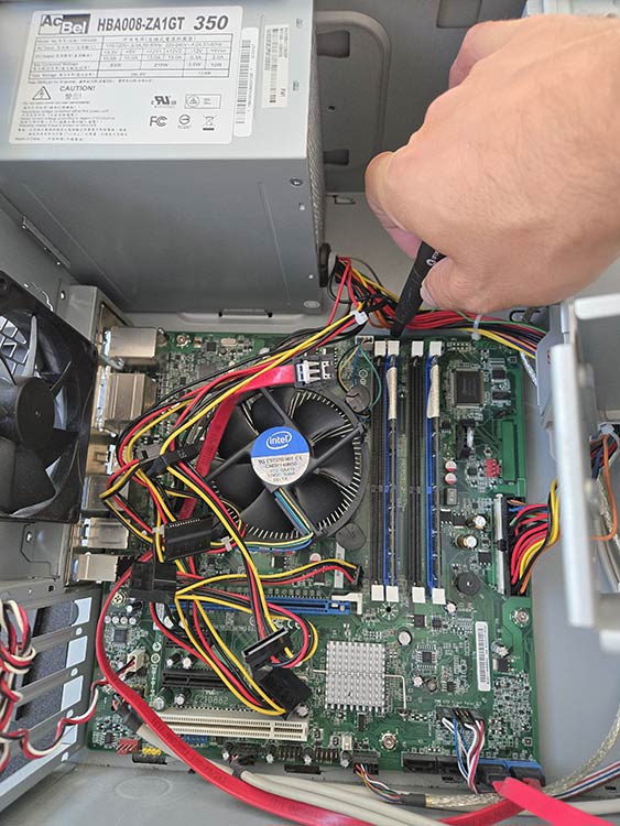 an IT tech replacing a motherboard